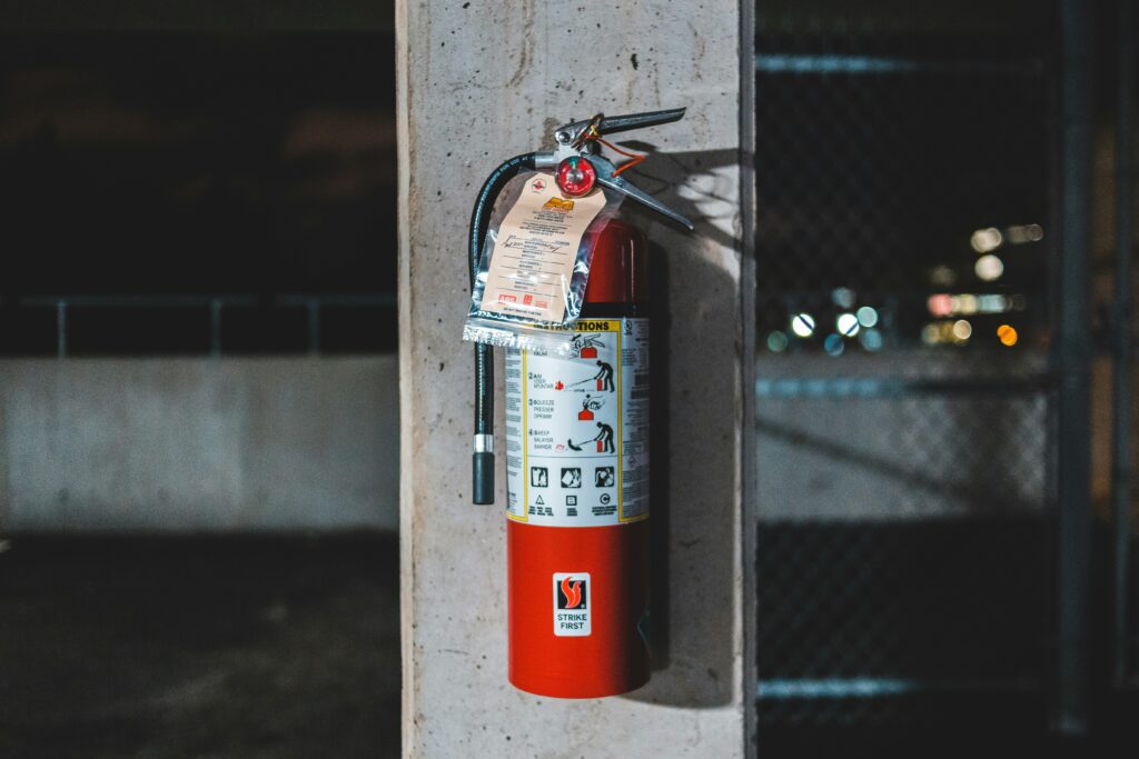 an image of a fire extinguisher mounted on a concrete column