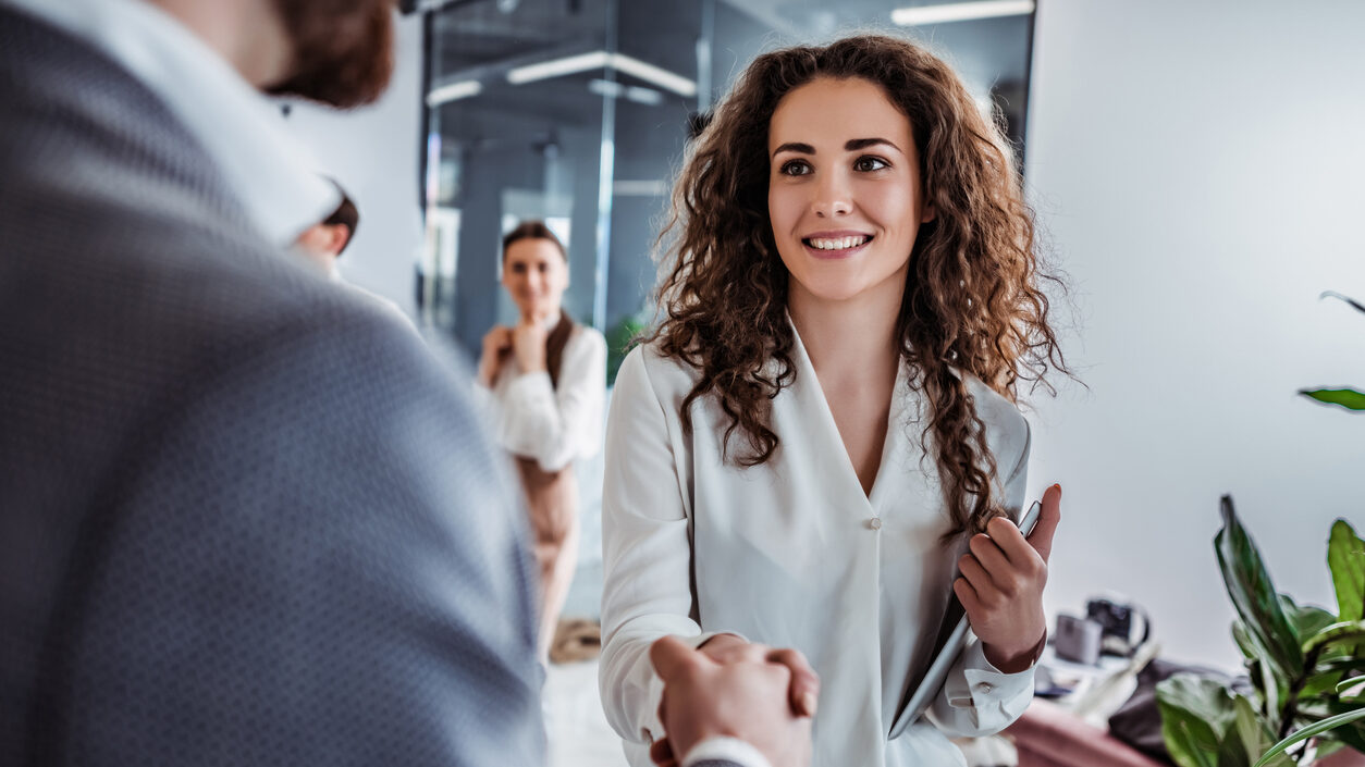 business woman shaking a man's hand